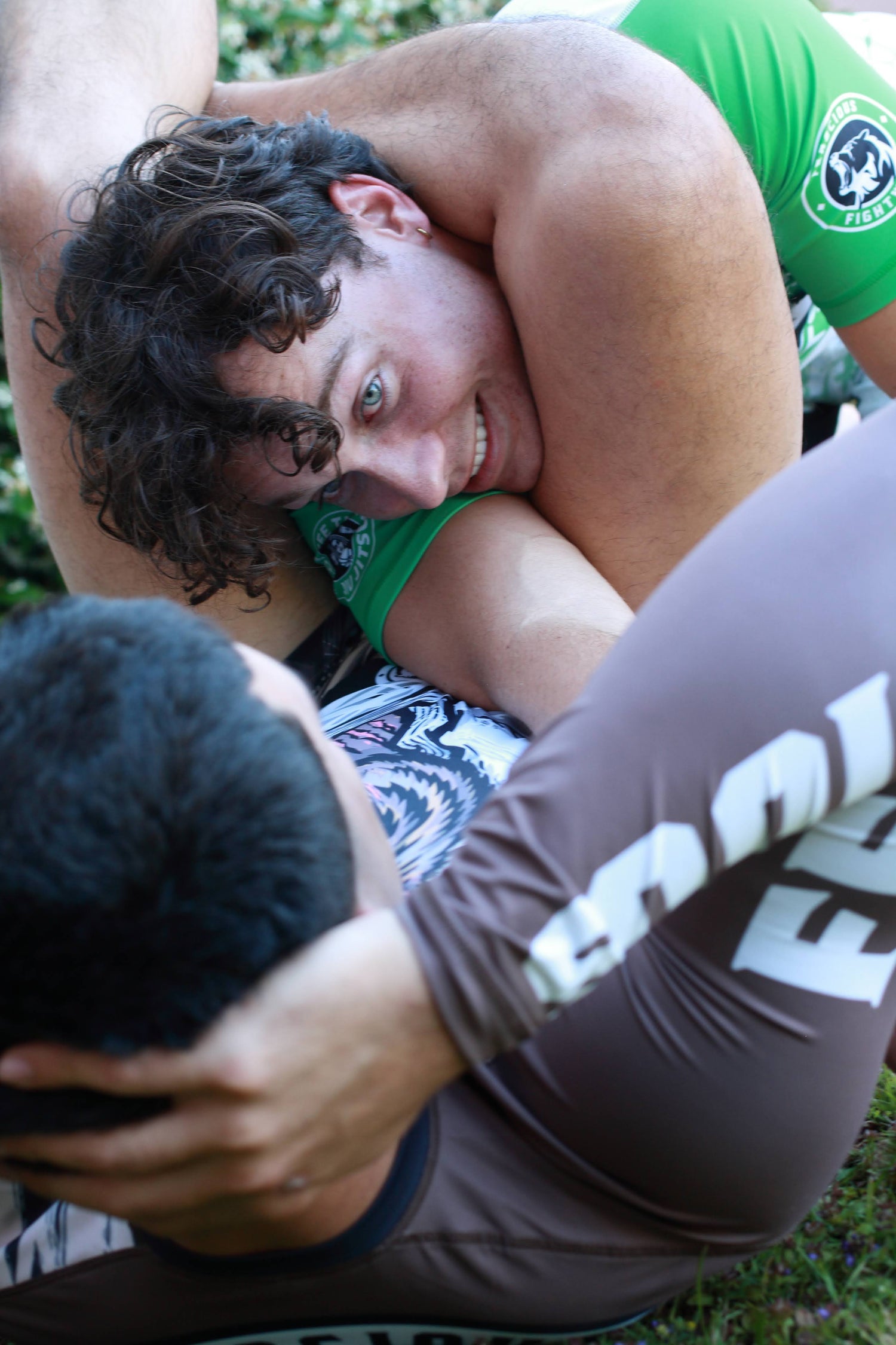 BJJ, Brazilian Jiu Jitsu Arm Bar Choke with two men wearing BJJ Rashguards and Ferocious MMA Shorts